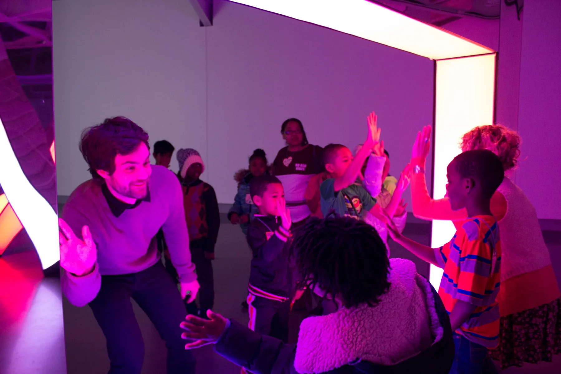 Michael Hollins engaging children during an arts workshop in KANEKO's Light environment