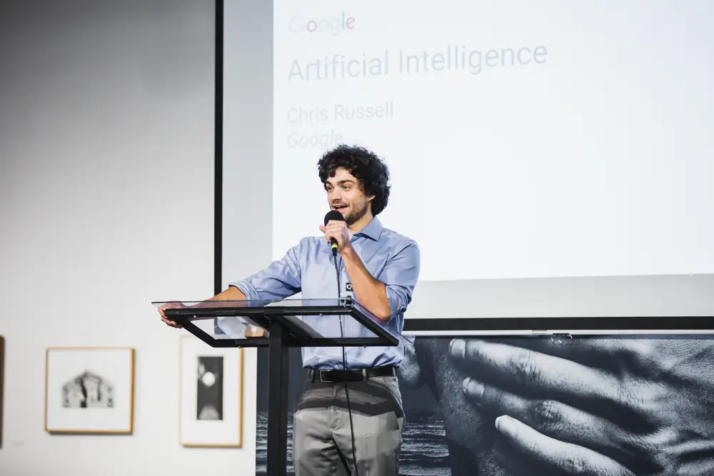 Michael Hollins introducing a presentation on artificial intelligence by Chris Russell of Google during Reality at KANEKO