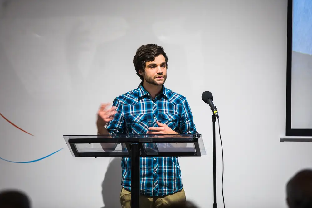 Michael Hollins presenting on stage during Reality at KANEKO