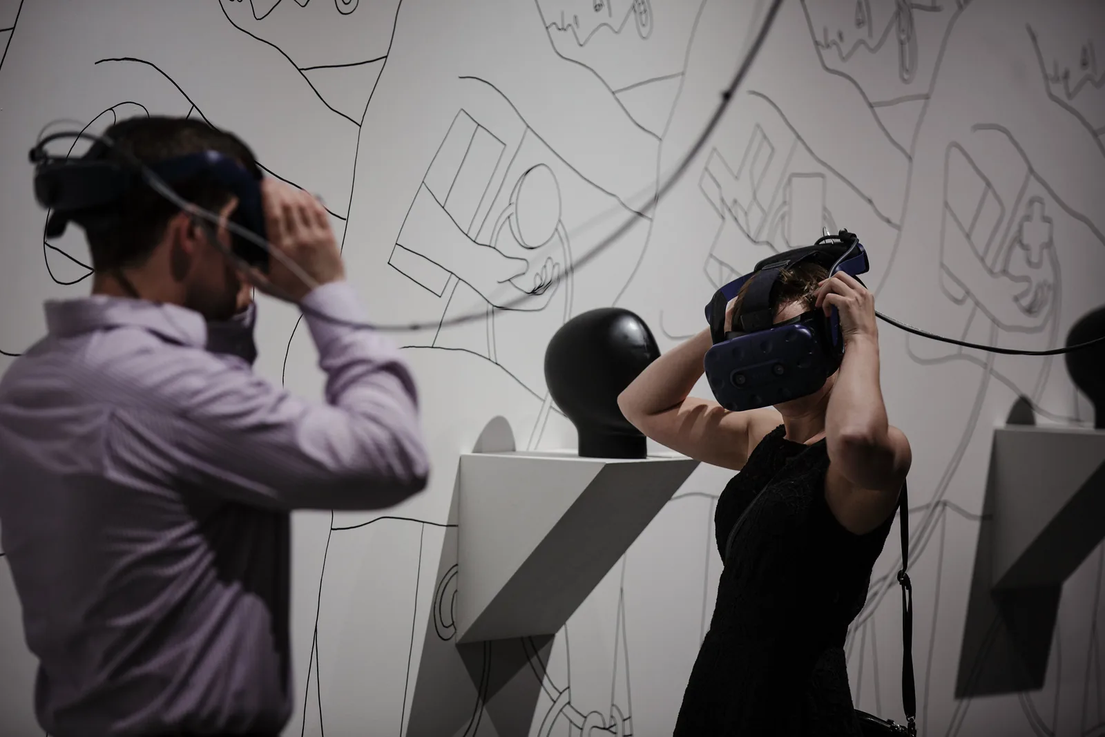 Visitors using head-mounted virtual reality displays in a public art installation during Reality at KANEKO in 2018