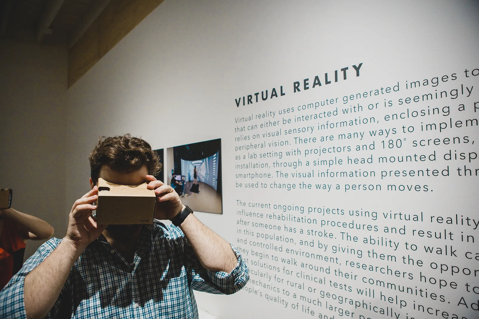 Michael Hollins using a virtual reality viewer in a public exhibit at KANEKO during Reality in 2018
