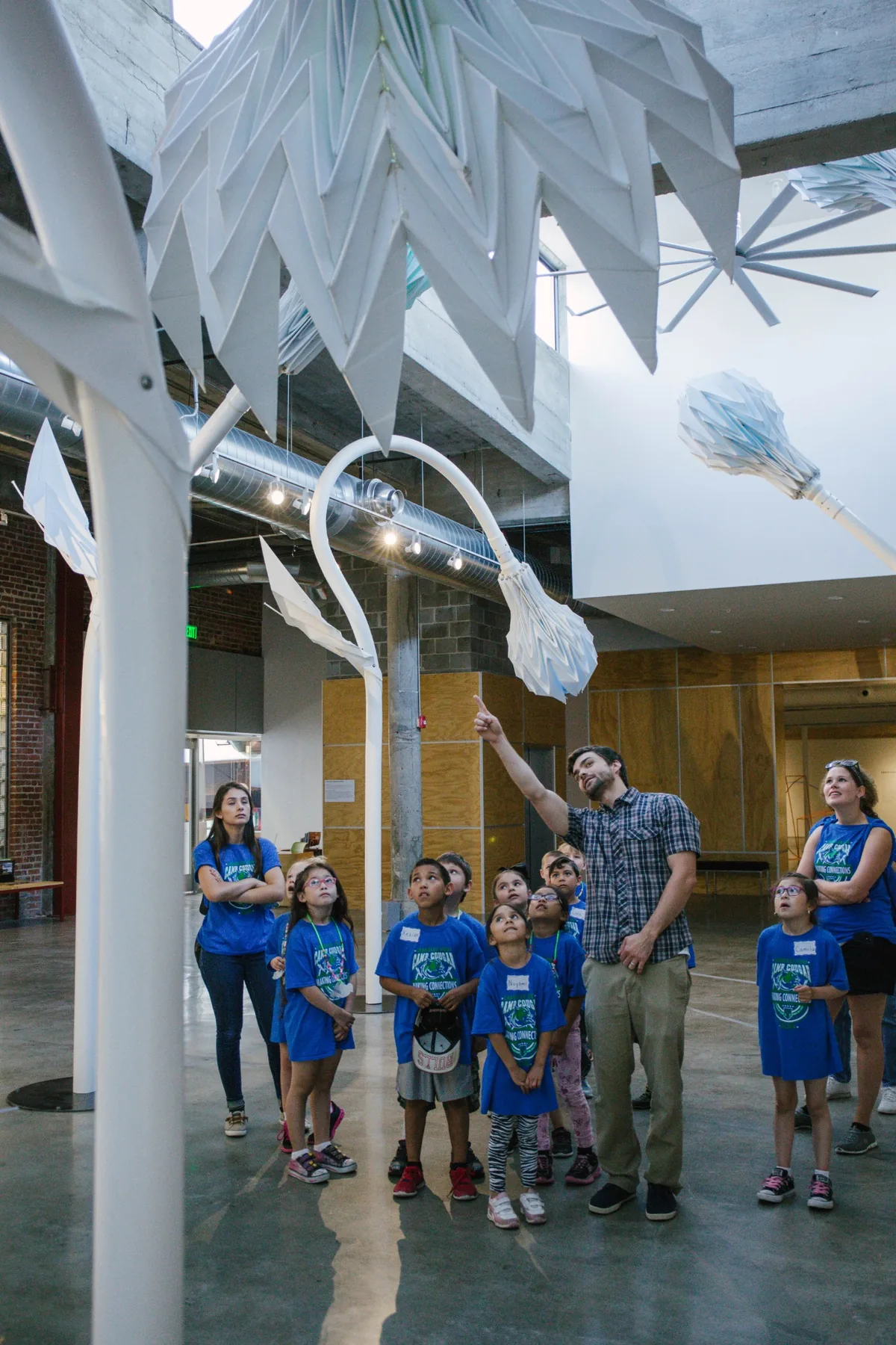 Michael Hollins guiding a group of students through an installation at KANEKO