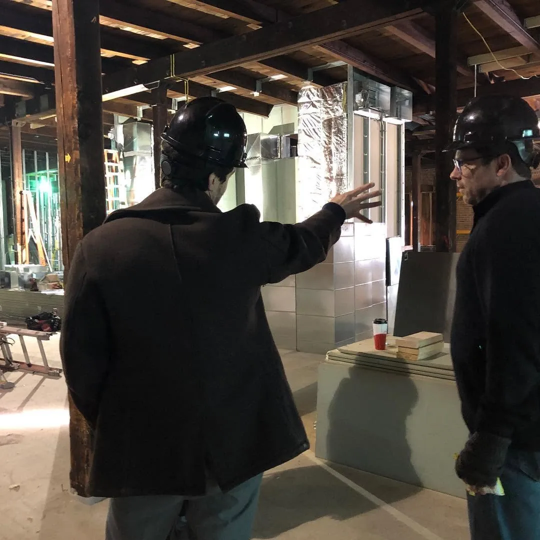 Michael Hollins gesturing during a construction-site design discussion at the Hoff Center