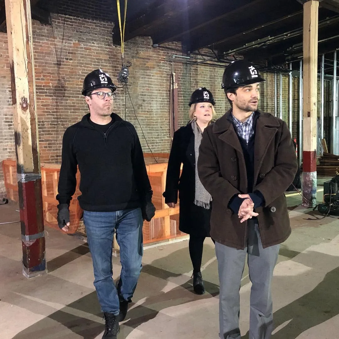 Michael Hollins and colleagues walking through the Hoff Center during construction